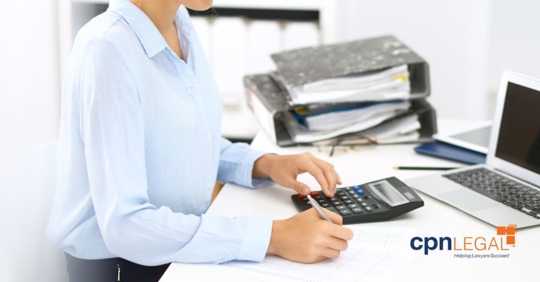 woman using laptop and calculator